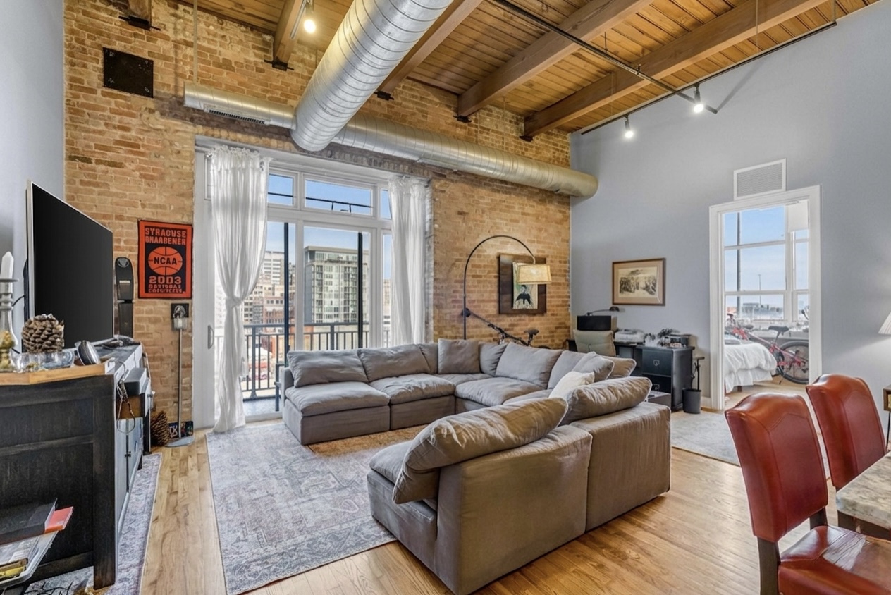 Living room — timber ceilings, exposed brick & balcony