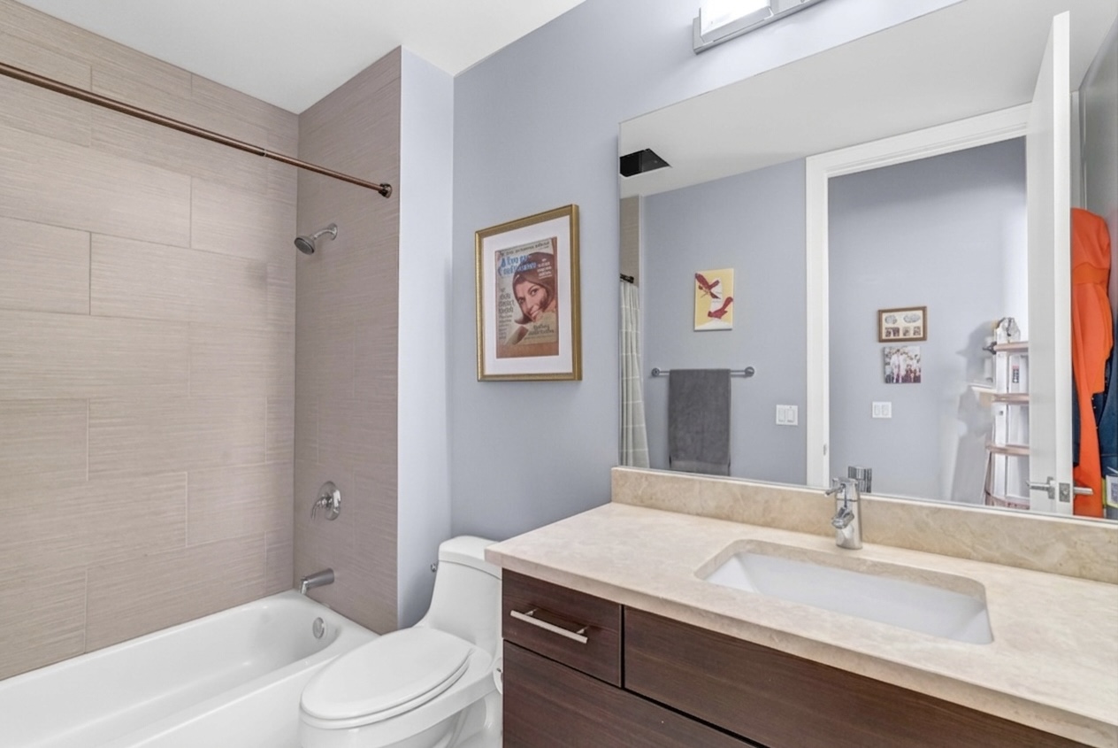 Bathroom — tiled tub & stone vanity